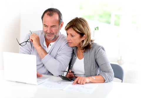 Two people looking at a computer.